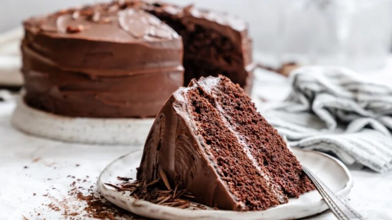 a slice of chocolate fudge cake on a plate.