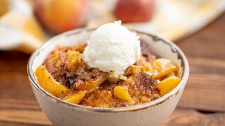Close up shot of peach cobbler on a bowl.