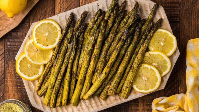 Smoked asparagus with lemon on a plate.