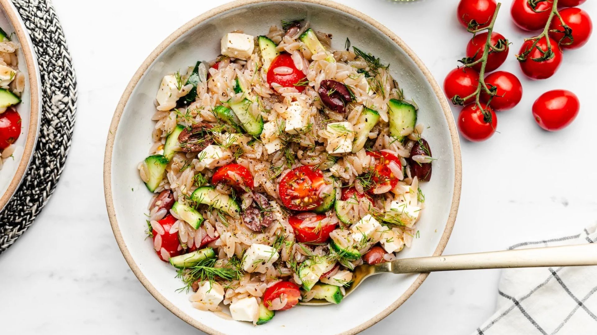 Orzo pasta salad on a plate.