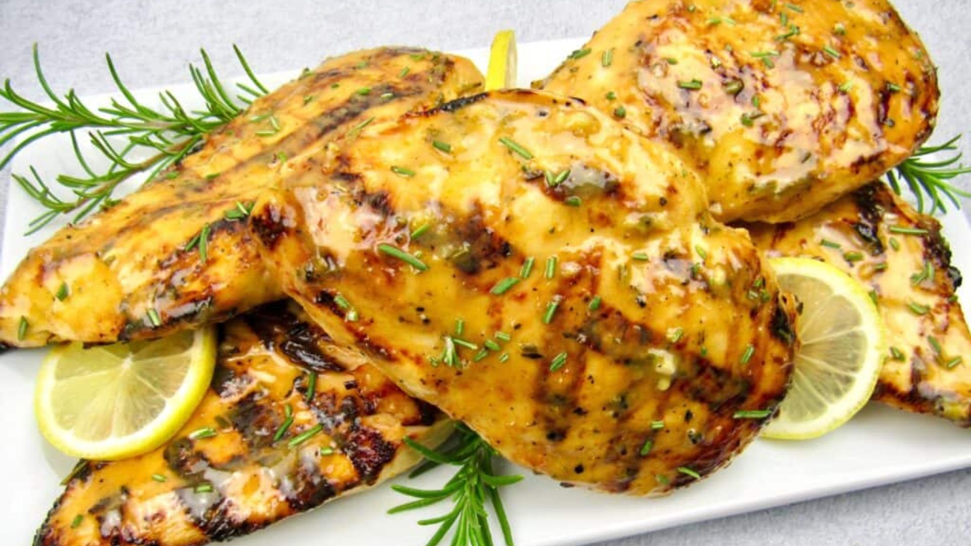 Close up shot of Grilled chicken with citrus glaze on a plate.