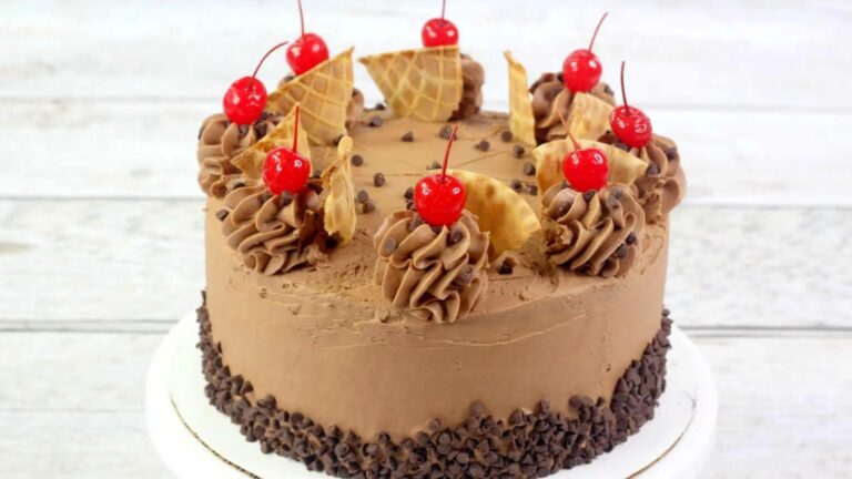 Mint chip cake with cherries on top.