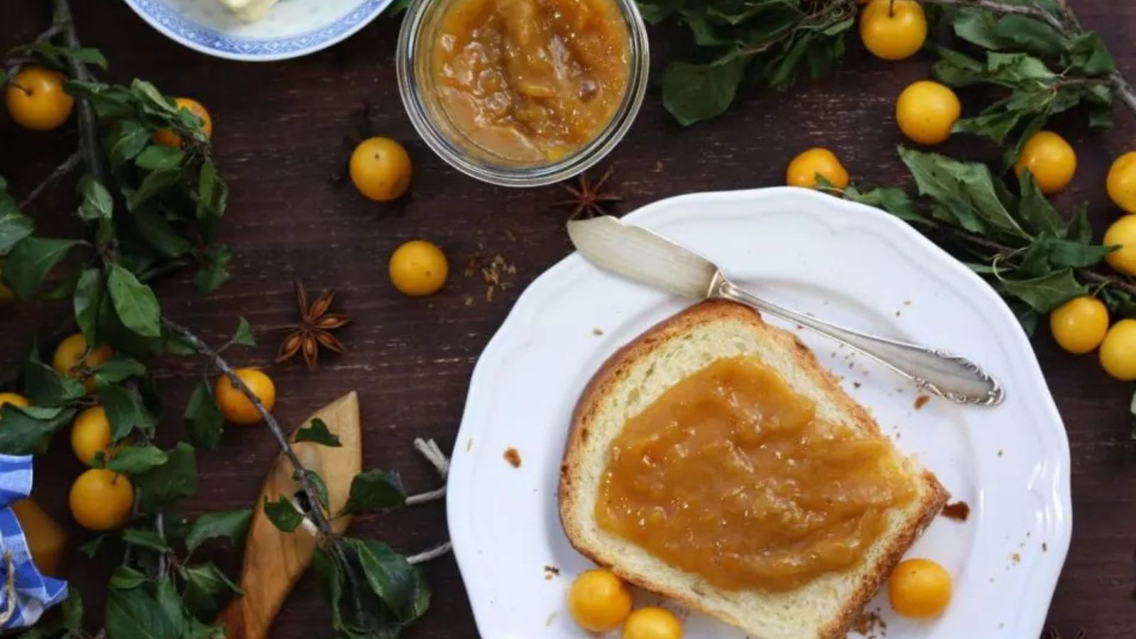 Wild plum jam in a jar and spread on toast.