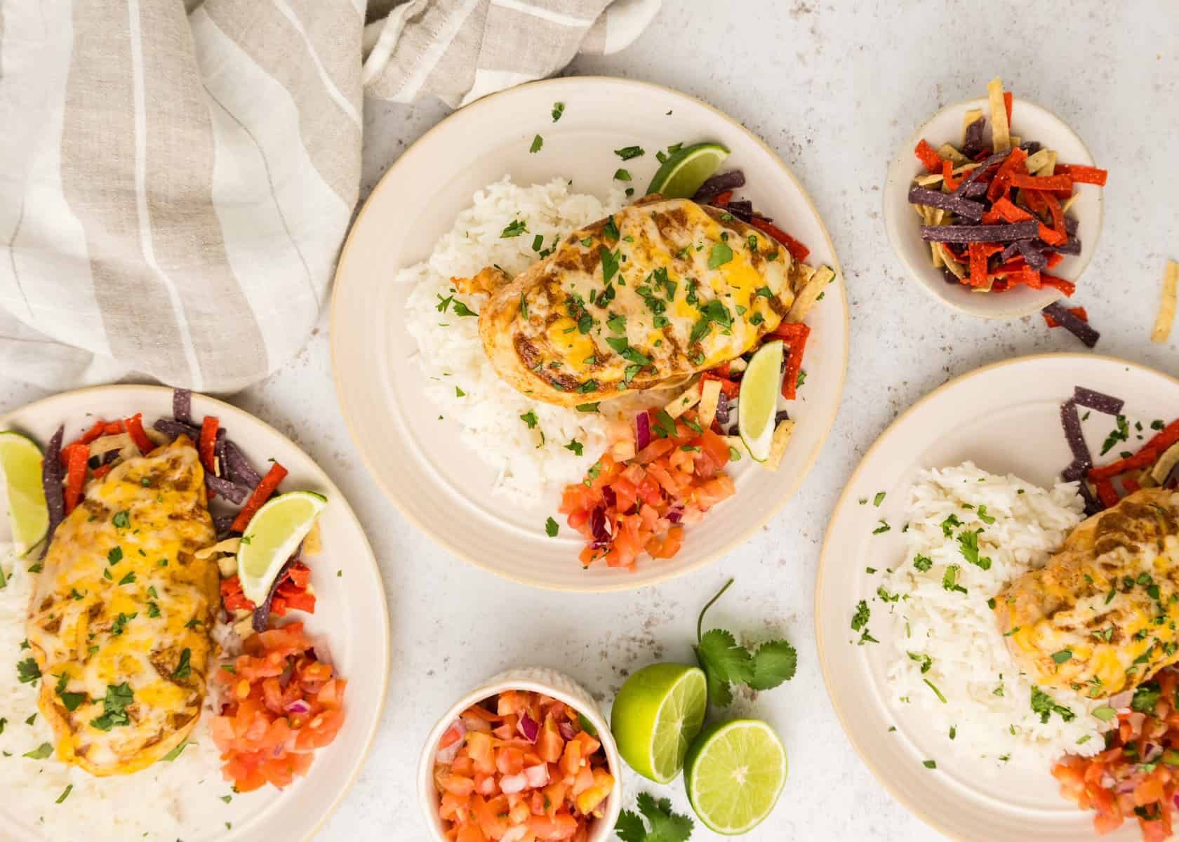 Three plates of colorful fiesta lime chicken.