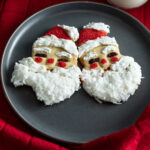 Santa Claus shaped cookies with a bite taken out.