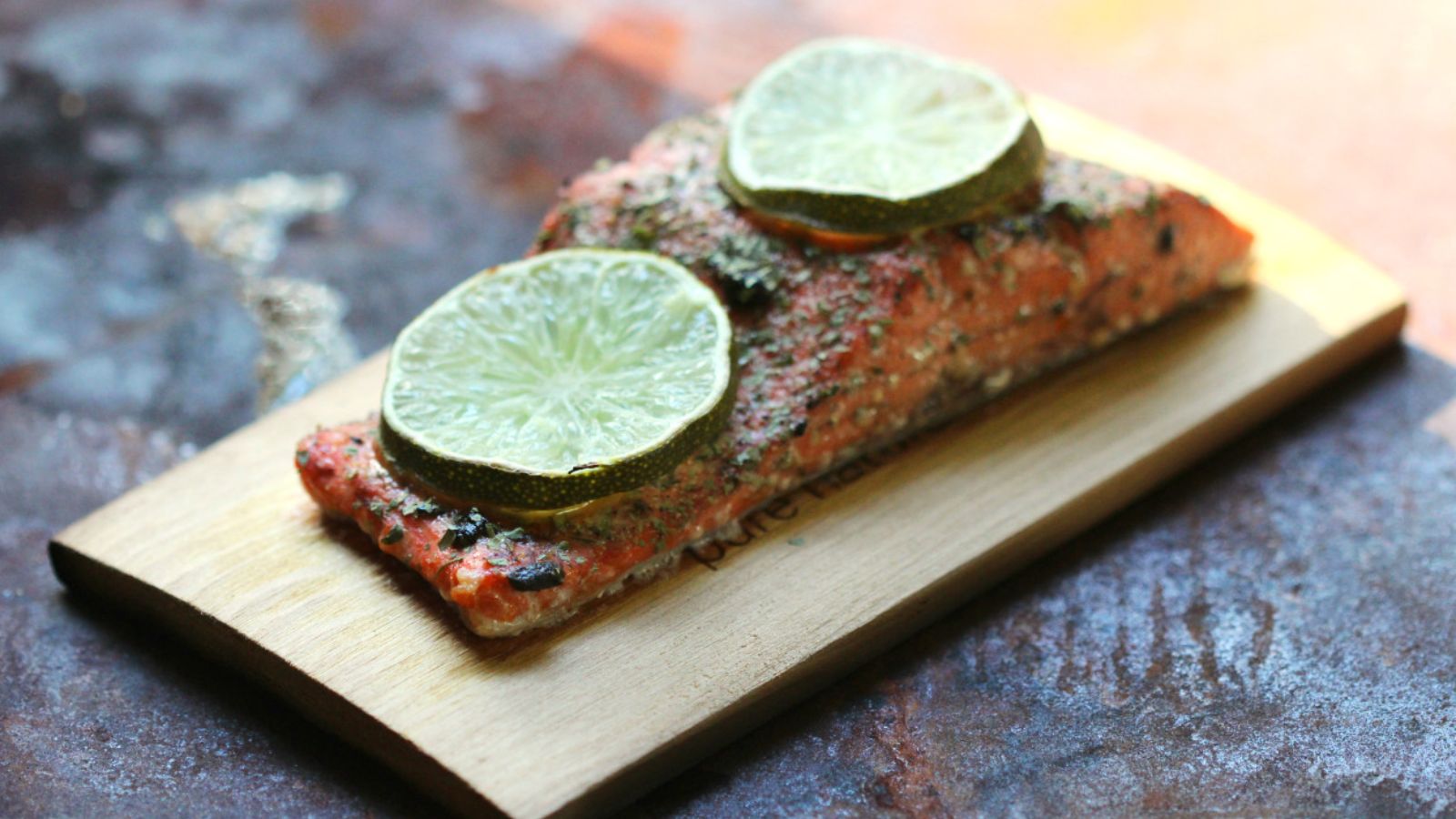 Salmon with sliced limes on top.