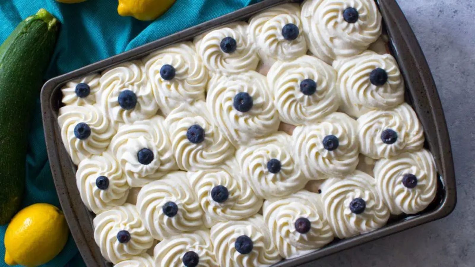 Top view shot of Blueberry Zucchini Poke Cake in a tray.