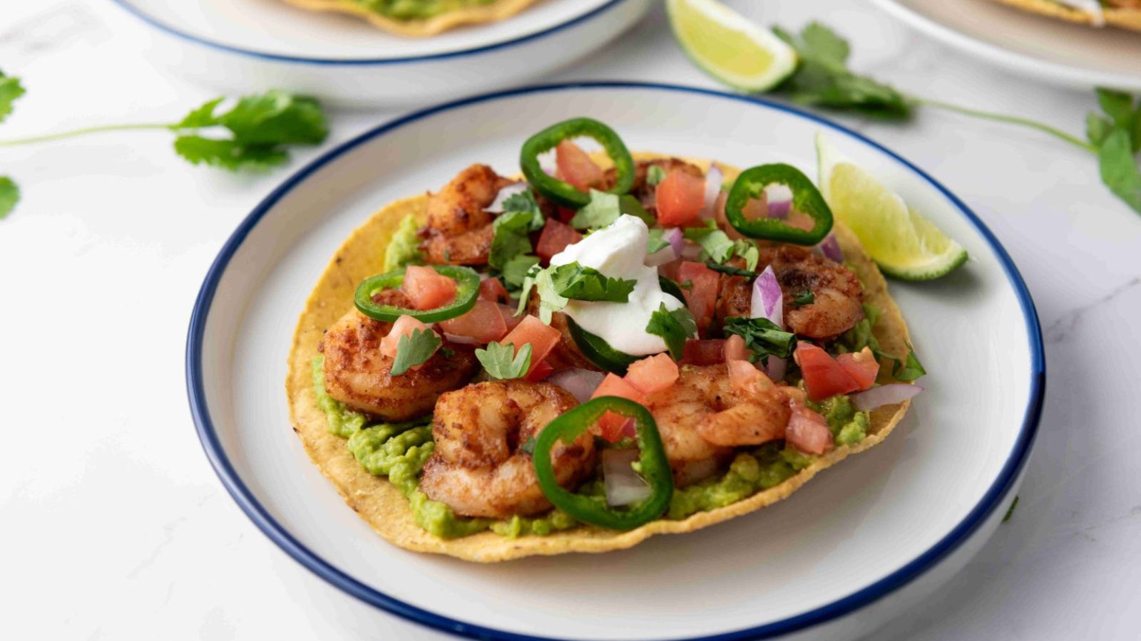 Crispy shrimp tostada on a plate.
