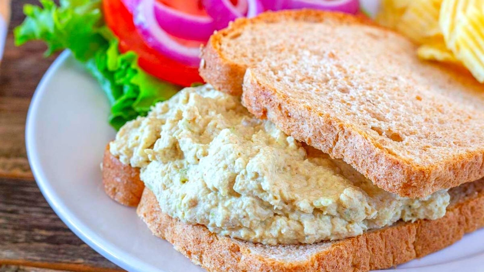 Close up shot of dijon chicken salad spread in a bread.