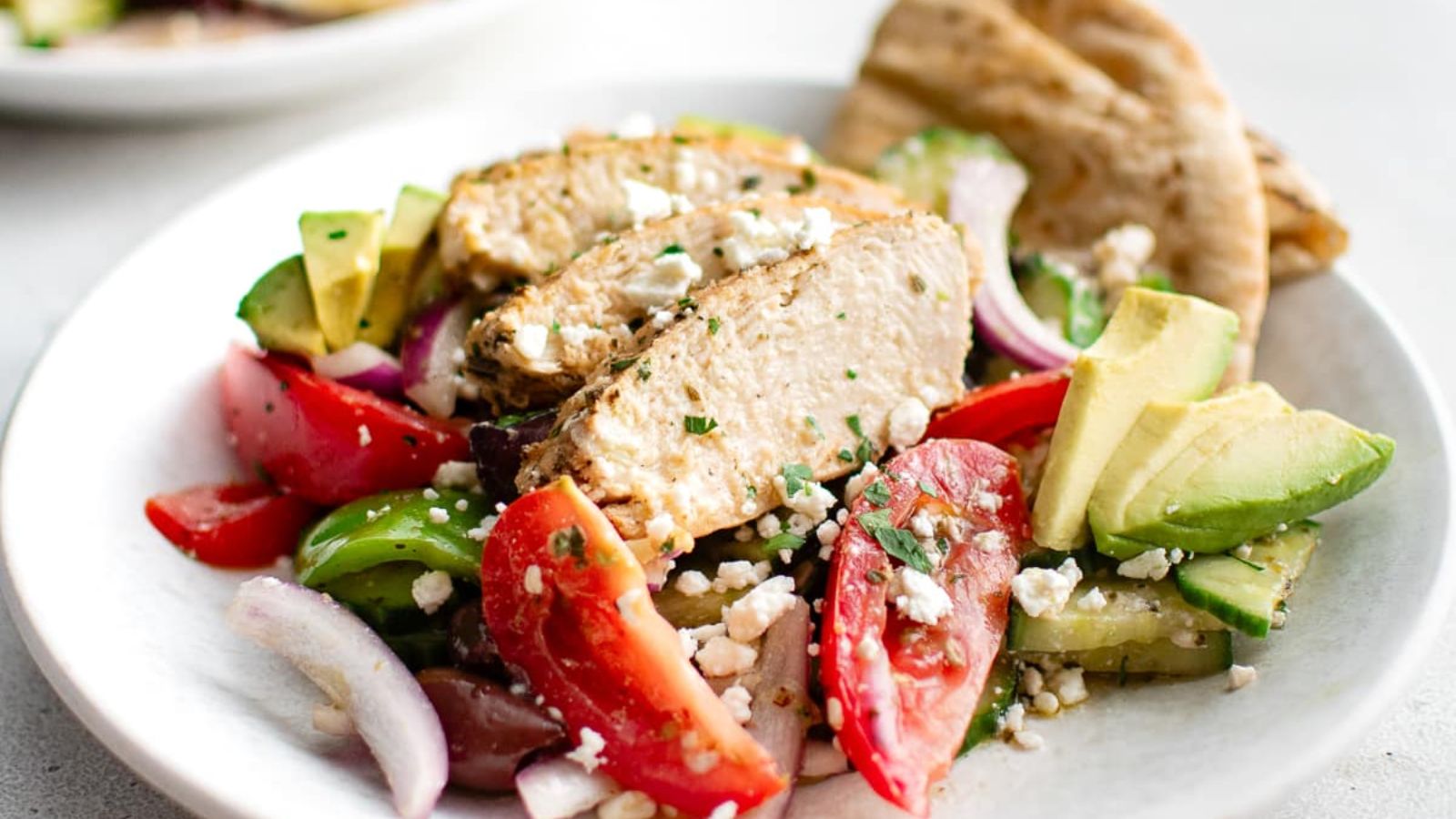 Close up shot of Greek Chicken Salad on plate.