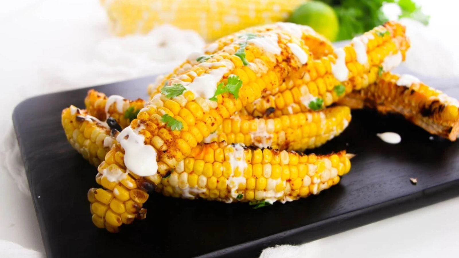 Grilled chili lime corn on a wooden board.