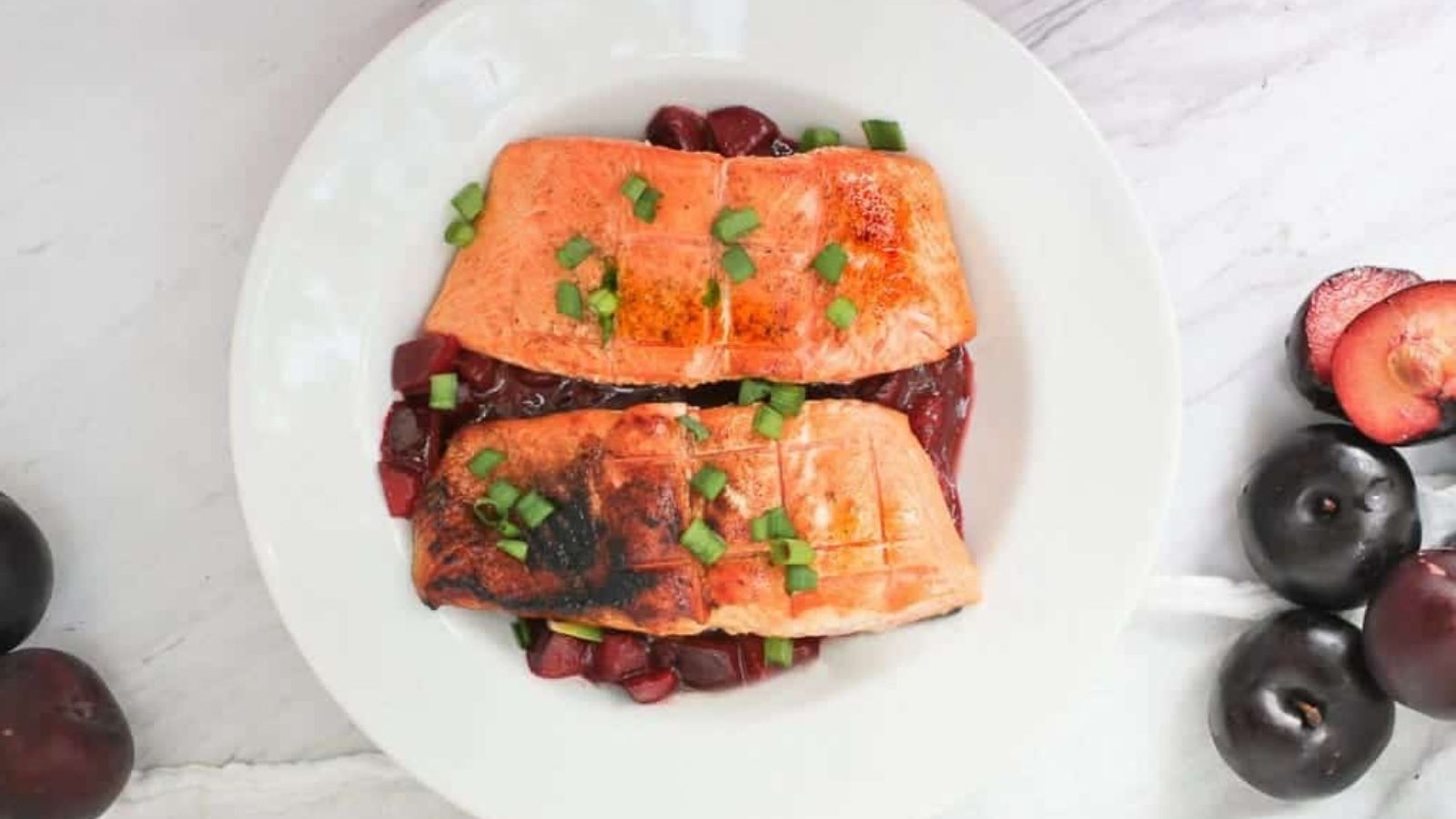 Top view shot of Grilled King Salmon with Plum Sauce on a plate.