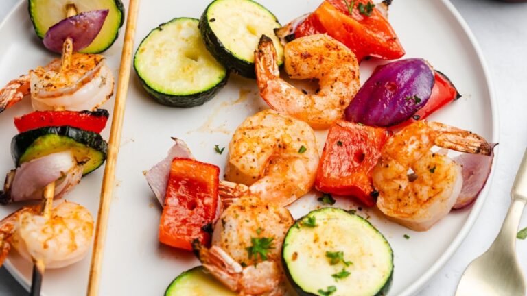 Shrimp kabobs on a plate.