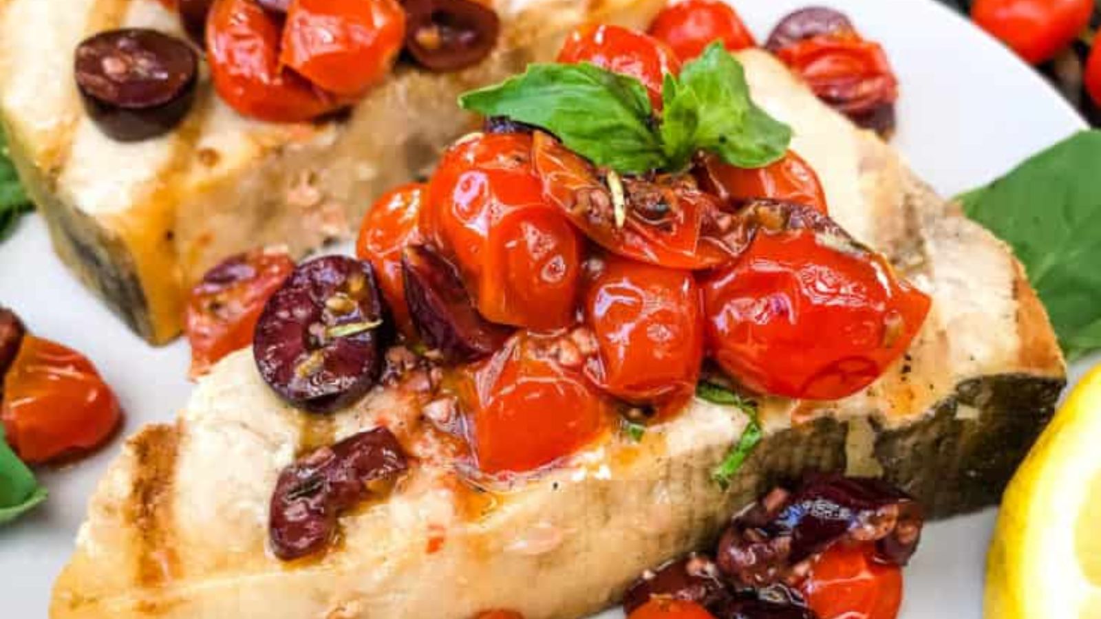 Close up shot of Grilled Swordfish Steak on a plate.