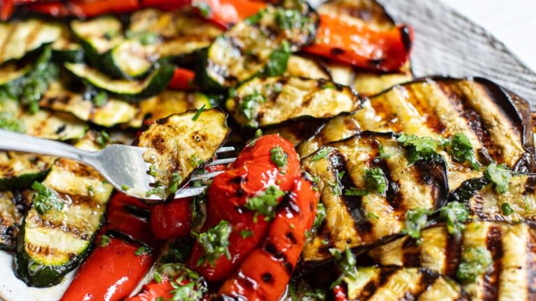 Grilled vegetables on a white platter.