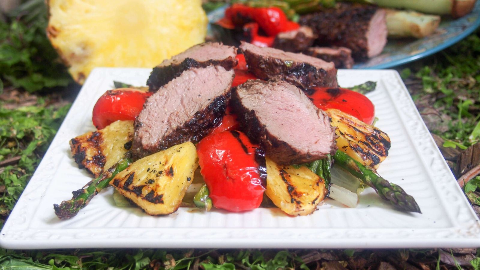 Grilled pork and pineapple on a plate.