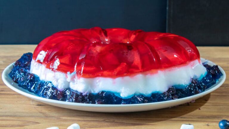 Red, white and blue jello salad on white platter.