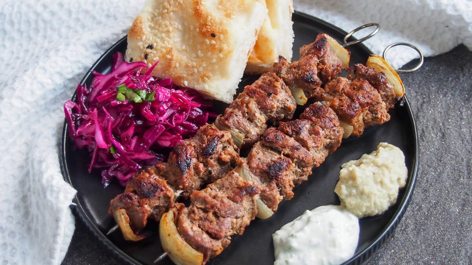 Lamb shish kebab on a plate.
