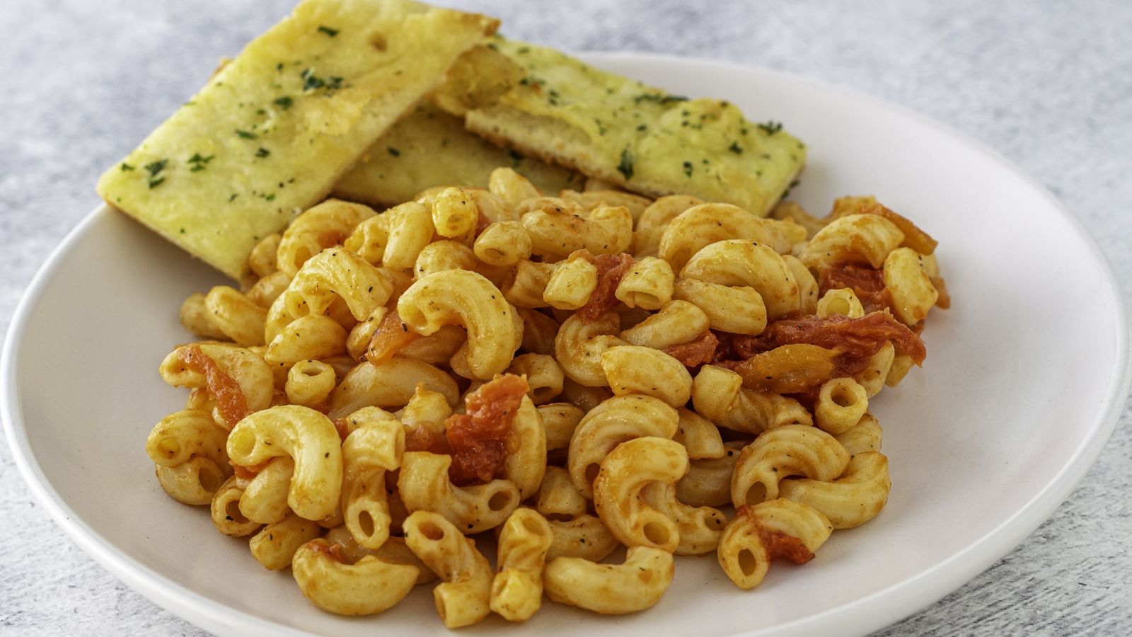 Macaroni and tomatoes on a plate.