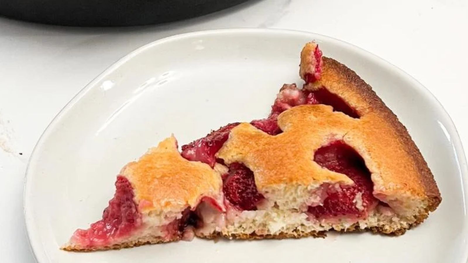 Sliced Skillet Strawberry Cobbler on a plate.