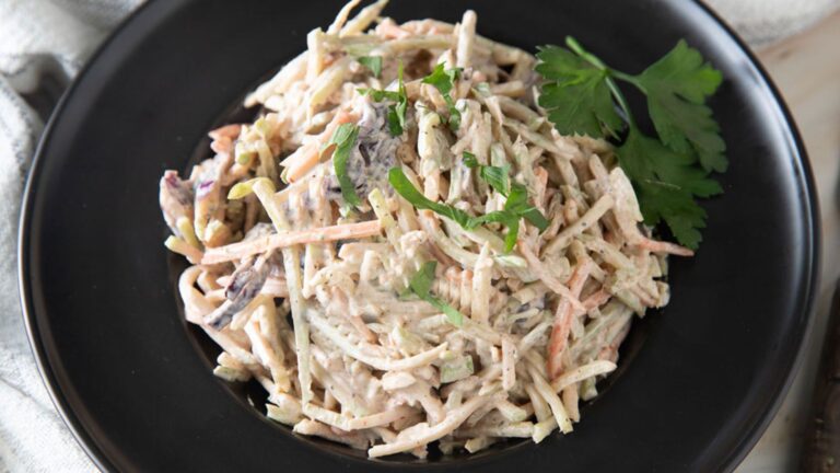 Spicy Coleslaw on a black plate.
