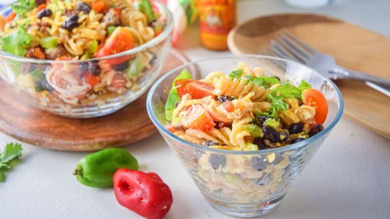 Two bowls of pasta salads.