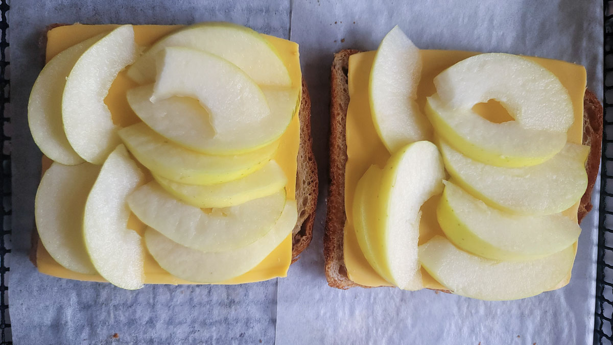 Apple slices stacked on the American cheese.