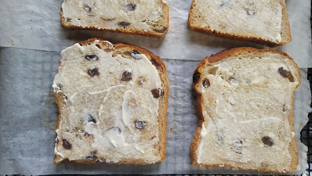 Mayonnaise spread on one side of the bread.