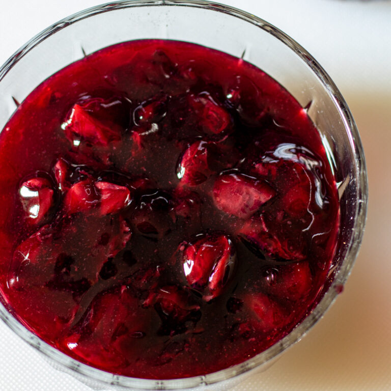 Cherry pie filling in a clear glass bowl.
