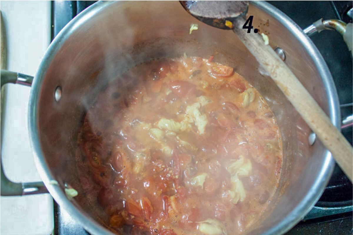 Onions and garlic added to the pot with the cooked down tomatoes.