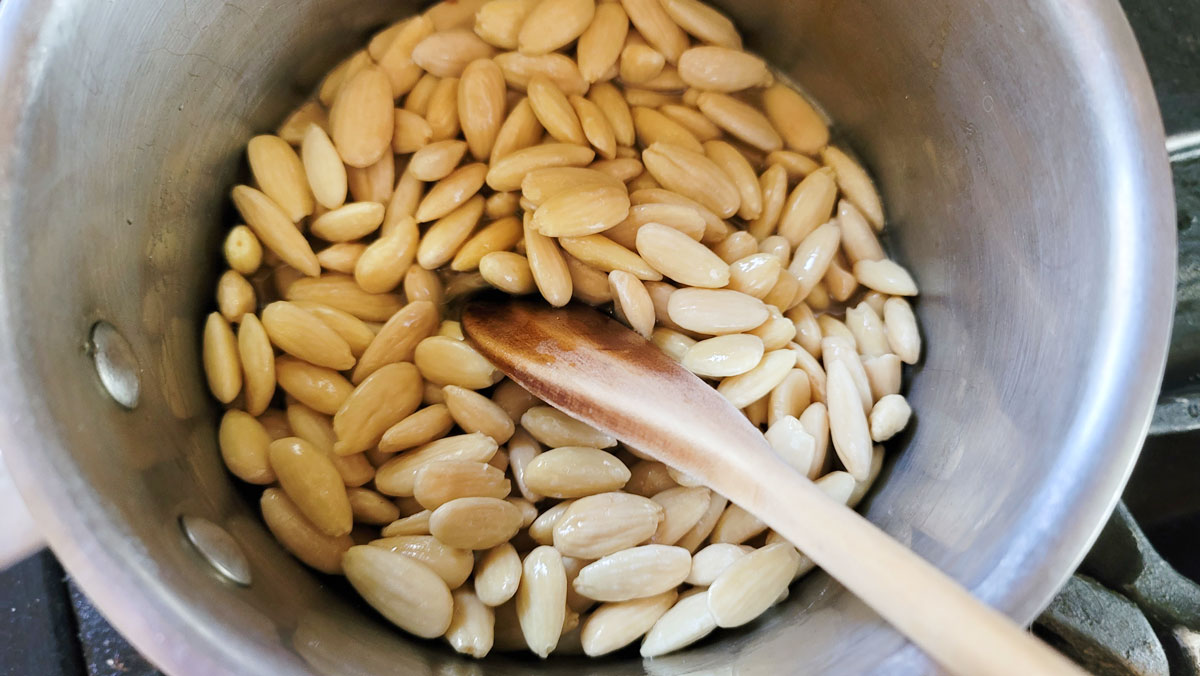 Nuts added to the liquid ingredients in the pan.
