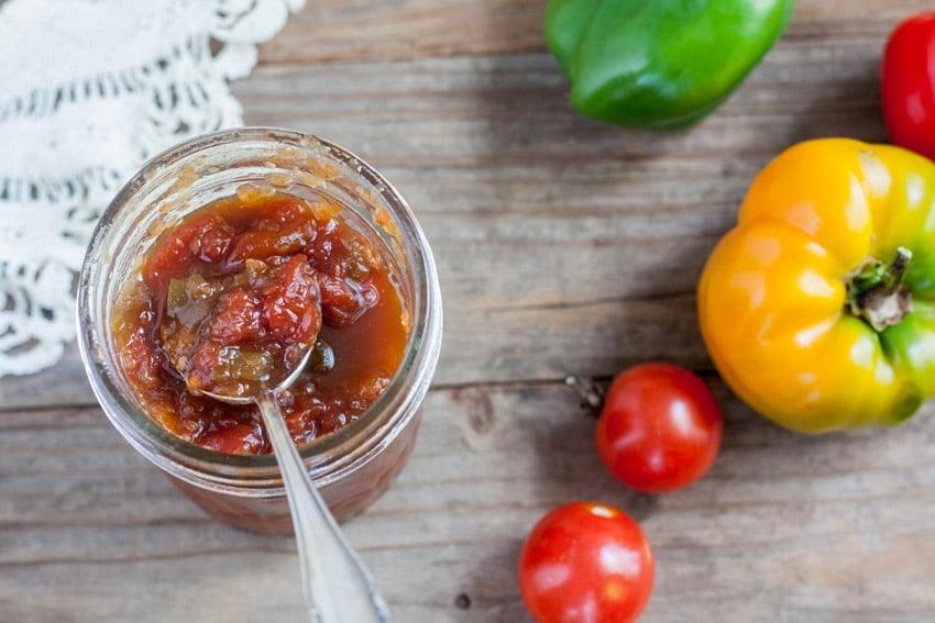 Open jar of Oscar Relish on antique barn wood table with antique doilies.