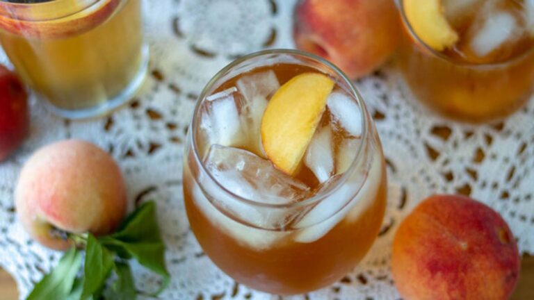 Top view shot of peach tea in a glass.