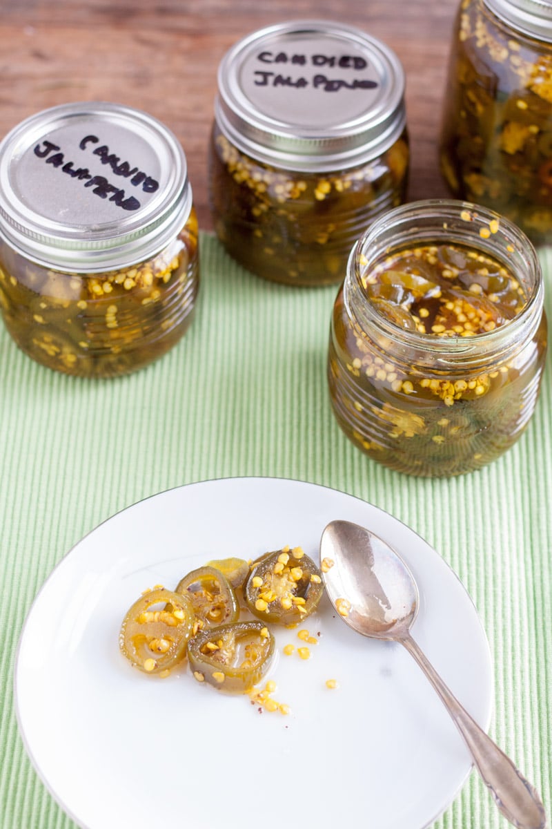 candied jalapenos on white plate with silver spoon
