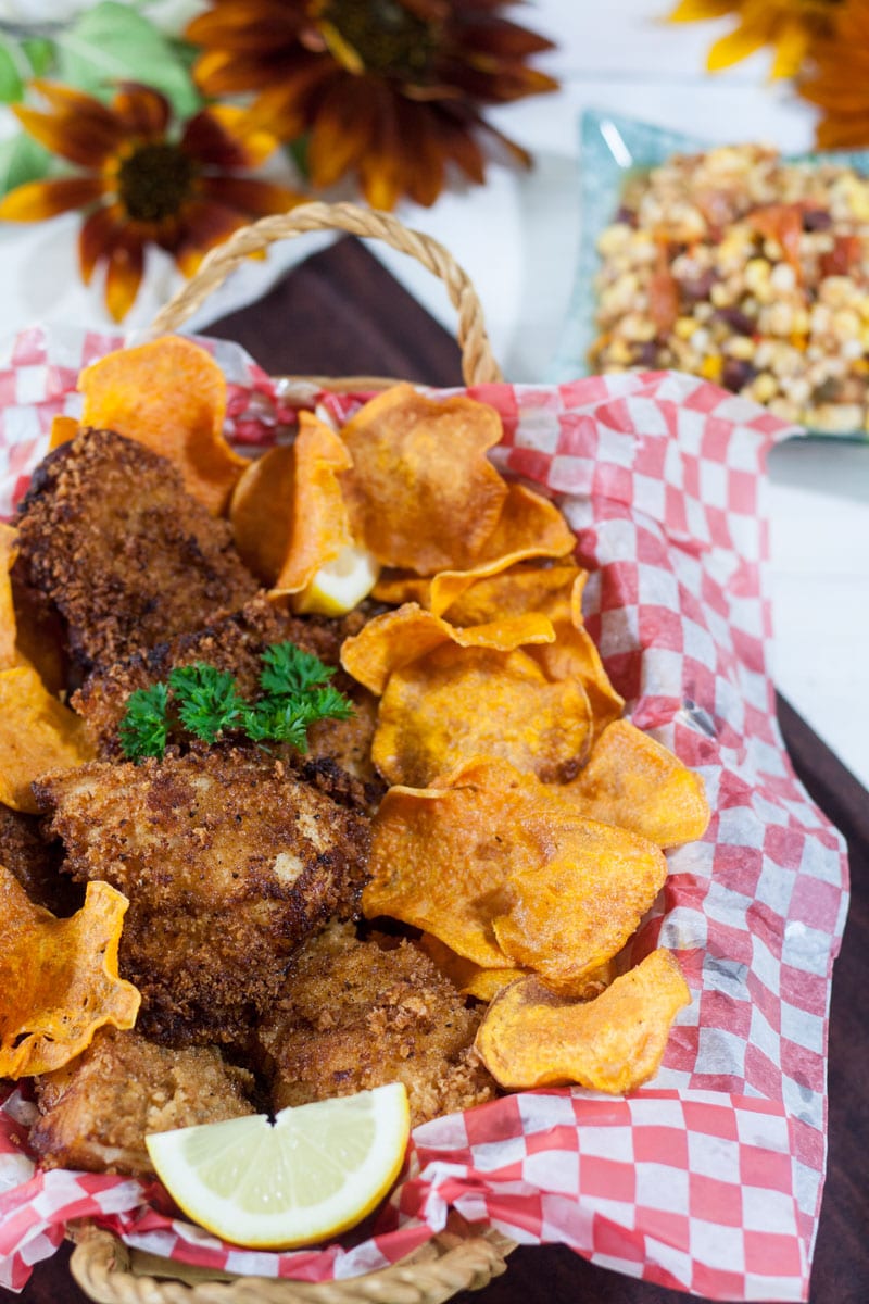 Basket filled with fried fish and sweet potato chips.