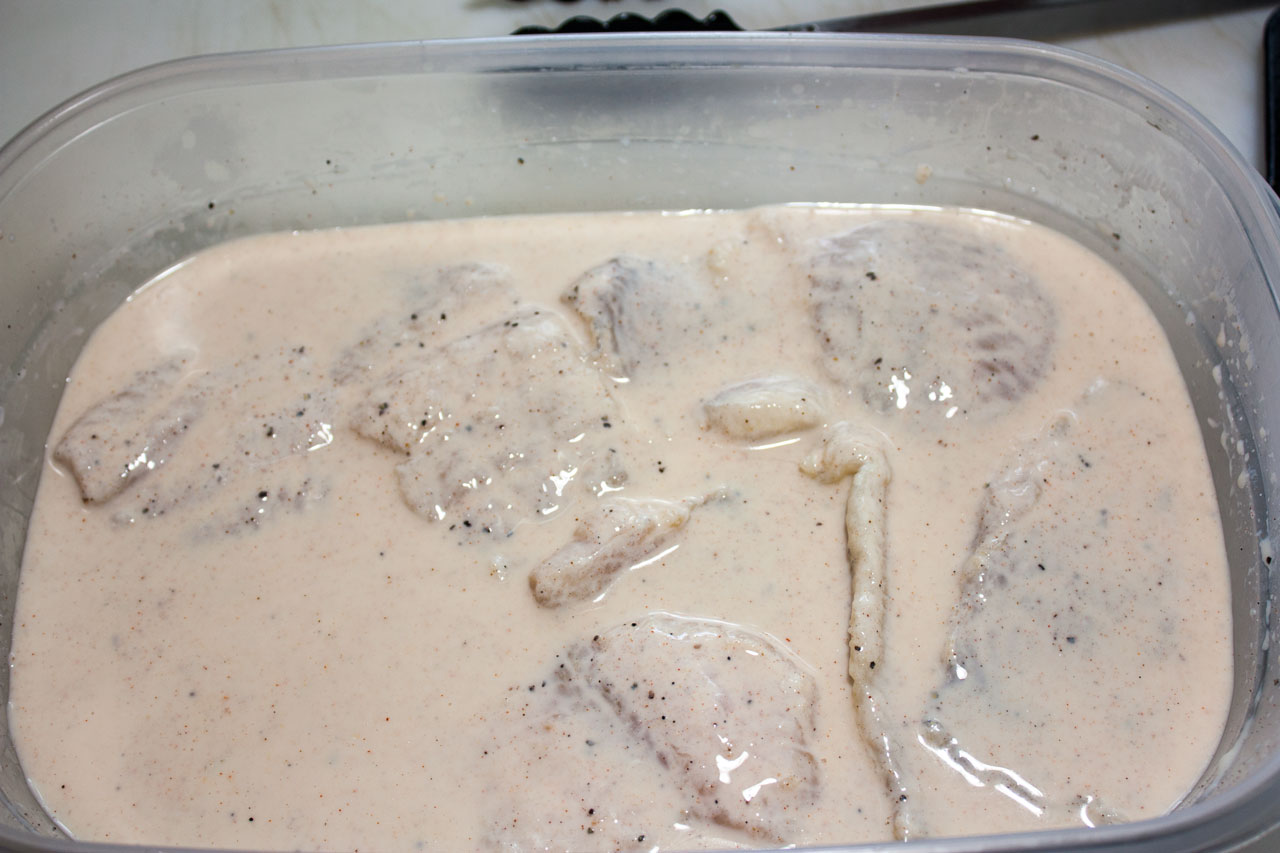 Fish filets soaking in the buttermilk mixture.