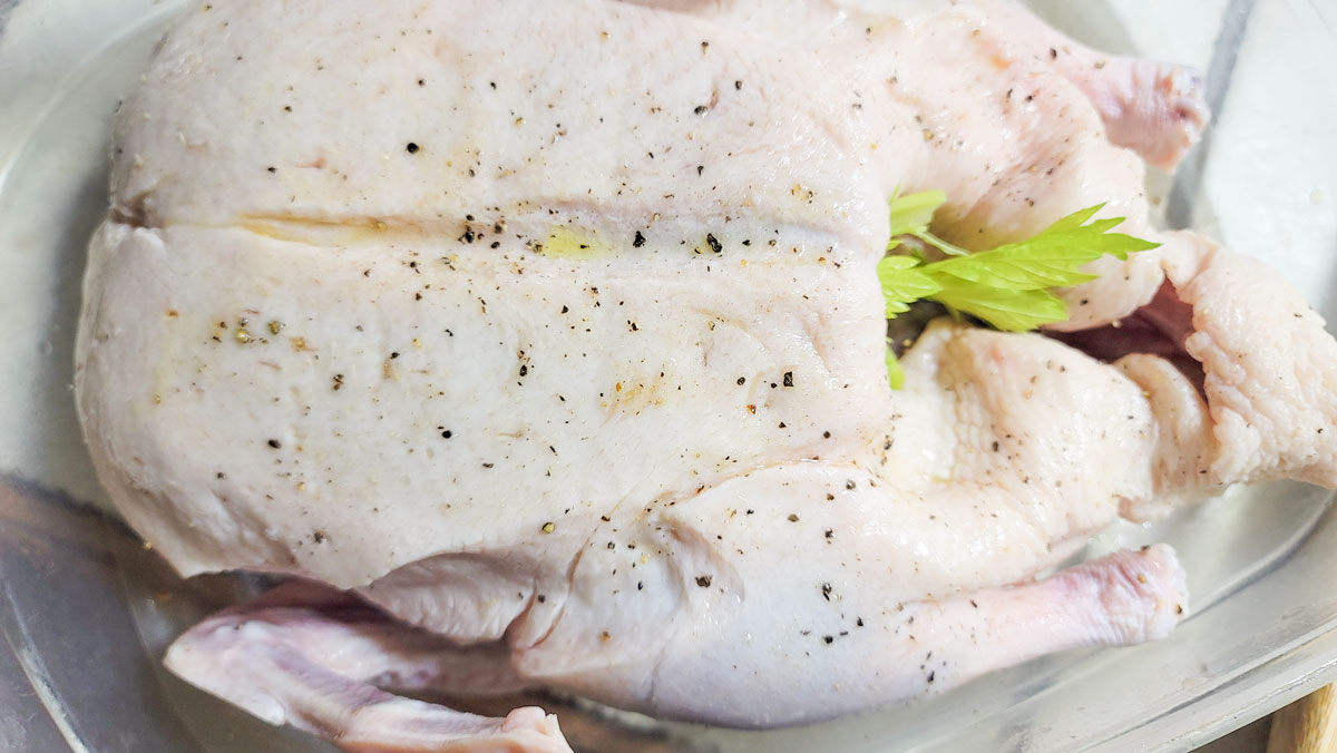 Duck seasoned with salt and pepper and stuffed with mire poix.