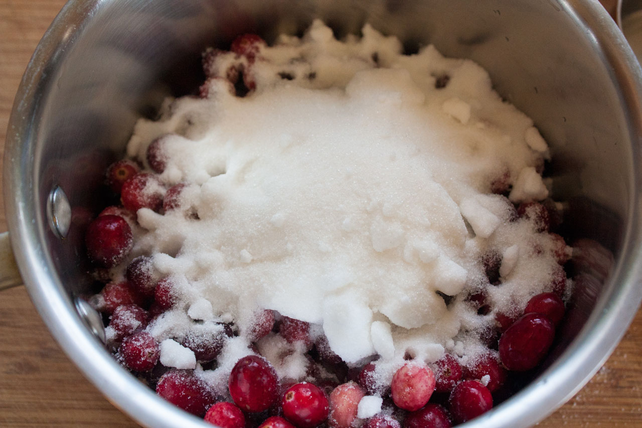 Sugar added to the cranberries in the pot.
