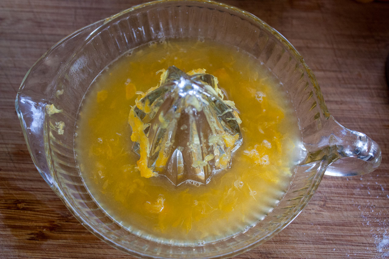 Freshly squeezed orange juice with pulp in a reemer.