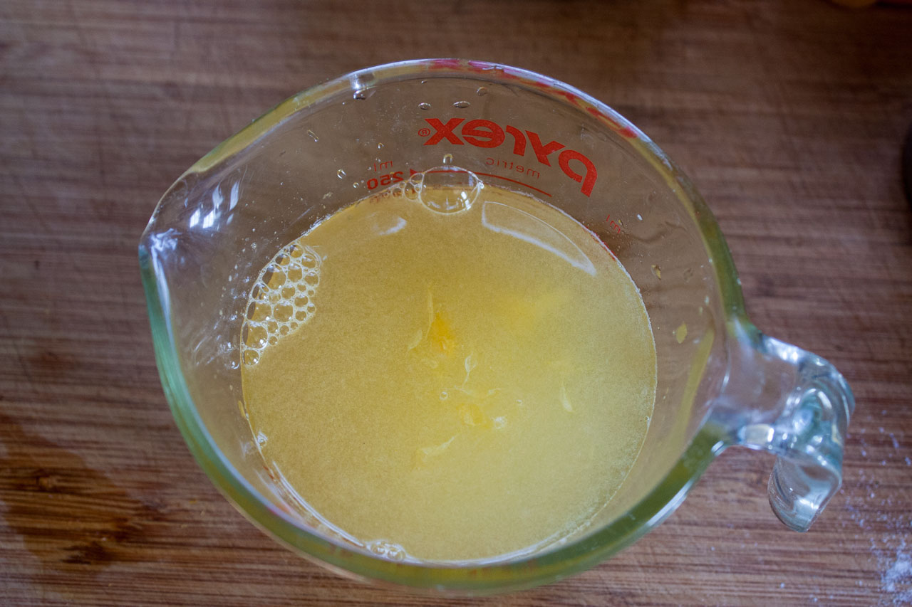 Water and liqueur added to the measuring cup.