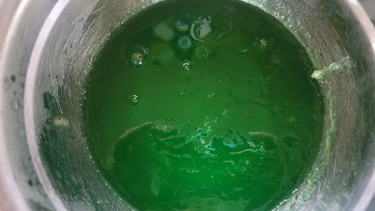Partially set jello in a metal bowl.