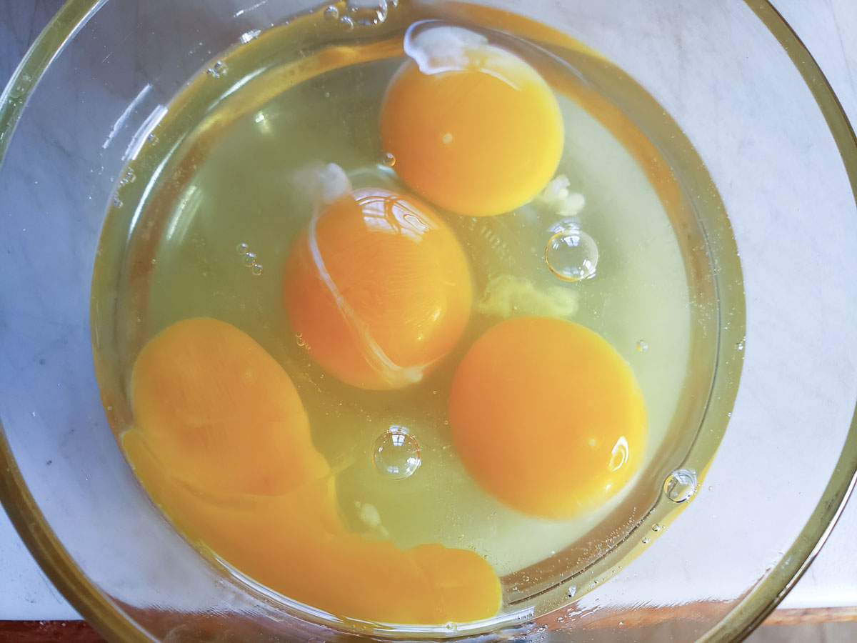 Cracked eggs in a small bowl.