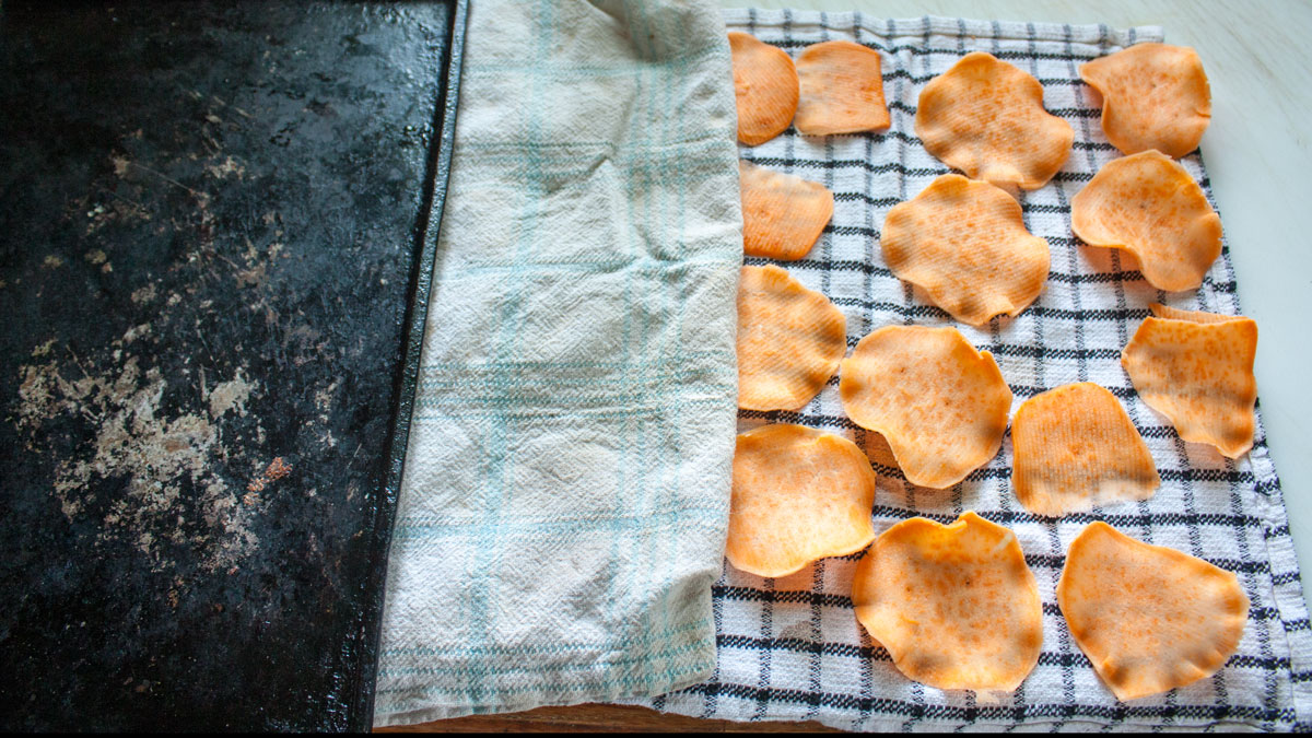 Drying slices in between clean kitchen towels.